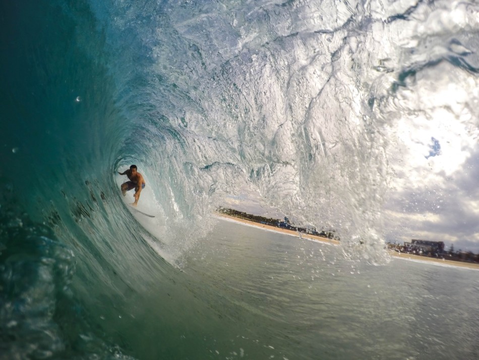 Man surfing within a wave