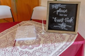Wedding guest book on table with decorated sign