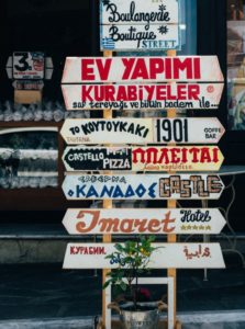 Many directional signs with various languages
